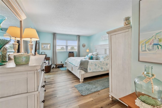 10216 Regal Dr Unit 310, Largo, FL 33774 - bedroom featuring a textured ceiling and light wood-type flooring