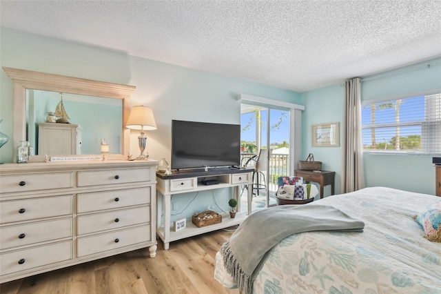10216 Regal Dr Unit 310, Largo, FL 33774 - bedroom with access to outside, wood finished floors, and a textured ceiling