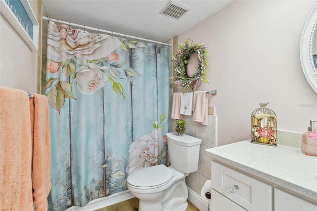 10216 Regal Dr Unit 310, Largo, FL 33774 - bathroom with toilet, vanity, and curtained shower