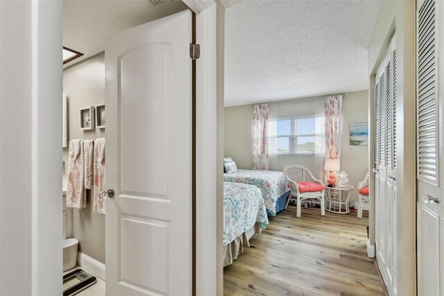 10216 Regal Dr Unit 310, Largo, FL 33774 - bedroom featuring wood finished floors and a textured ceiling