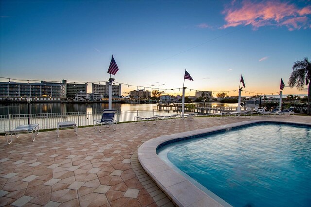 10216 Regal Dr Unit 310, Largo, FL 33774 - community pool featuring a water view, fence, and a patio area