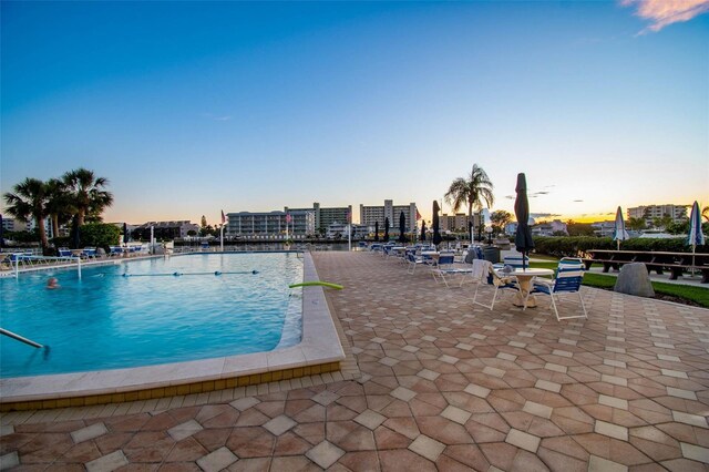 10216 Regal Dr Unit 310, Largo, FL 33774 - pool at dusk featuring a community pool and a patio area