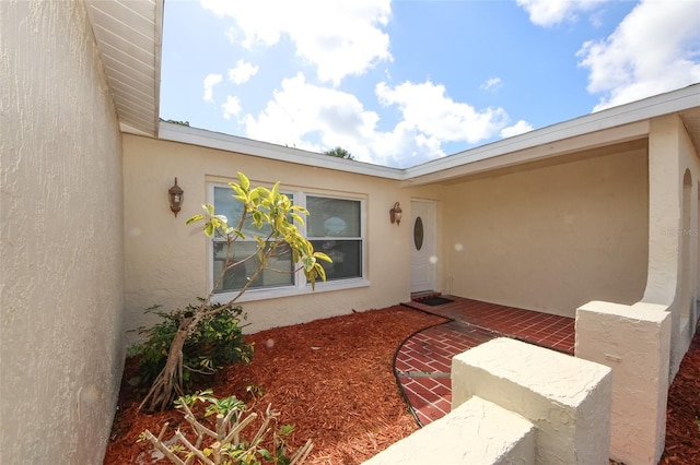 9816 Crofton Ln, Port Richey, FL 34668 - doorway to property featuring stucco siding