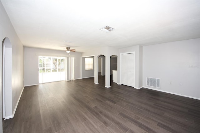 9816 Crofton Ln, Port Richey, FL 34668 - unfurnished living room featuring arched walkways, ceiling fan, and dark wood finished floors