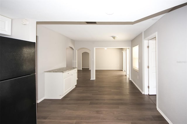 9816 Crofton Ln, Port Richey, FL 34668 - hall with dark wood-style floors, baseboards, and arched walkways