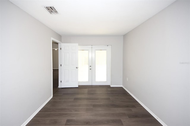 9816 Crofton Ln, Port Richey, FL 34668 - empty room featuring french doors, baseboards, and wood finished floors
