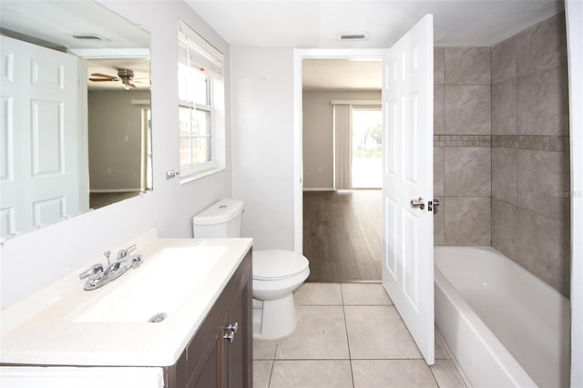 9816 Crofton Ln, Port Richey, FL 34668 - bathroom with toilet, ceiling fan, vanity, and plenty of natural light