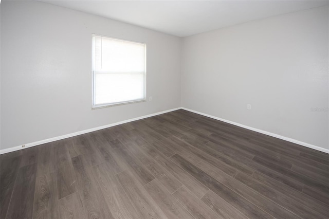 9816 Crofton Ln, Port Richey, FL 34668 - spare room with baseboards and dark wood-type flooring