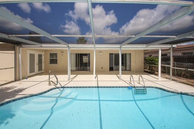 9816 Crofton Ln, Port Richey, FL 34668 - view of swimming pool with a patio, fence, glass enclosure, and french doors