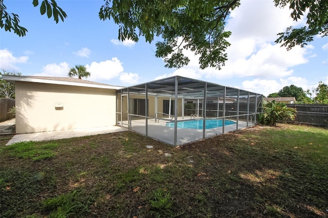 9816 Crofton Ln, Port Richey, FL 34668 - back of property featuring a fenced backyard, stucco siding, a patio, and a lanai