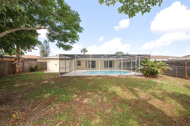 9816 Crofton Ln, Port Richey, FL 34668 - back of property featuring a lanai, stucco siding, and a patio