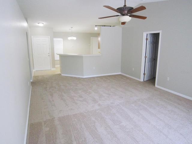 24741 Ravello St, Land O Lakes, FL 34639 - unfurnished living room featuring a chandelier, a ceiling fan, light carpet, and baseboards