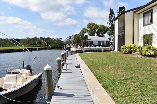 420 Moorings Cove Dr Unit 420, Tarpon Springs, FL 34689 - dock with a water view and a yard