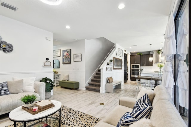 living area with stairway, recessed lighting, and baseboards
