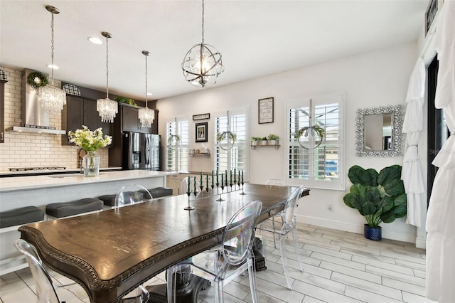 dining space with a chandelier, baseboards, recessed lighting, and light wood-type flooring
