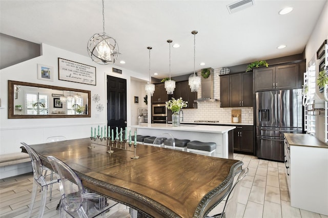 dining space with a chandelier and recessed lighting