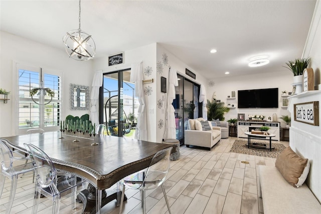 dining room with a chandelier and recessed lighting