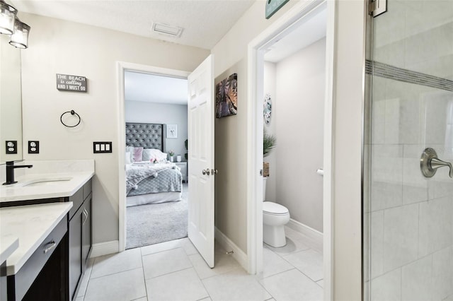 full bathroom with vanity, toilet, tiled shower, and ensuite bathroom