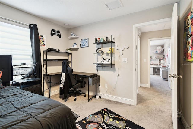 bedroom with carpet, baseboards, and an office area