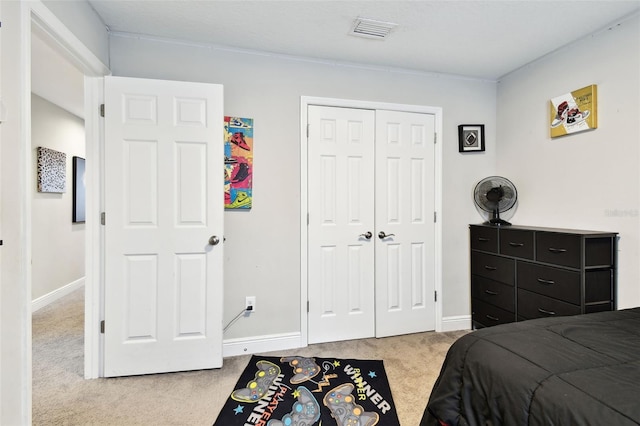 carpeted bedroom with baseboards and a closet