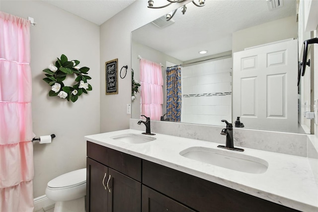 bathroom featuring toilet, double vanity, a shower with curtain, and recessed lighting