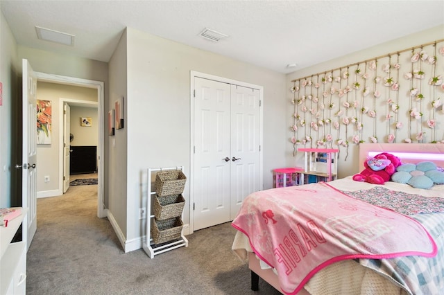 carpeted bedroom featuring a closet and baseboards
