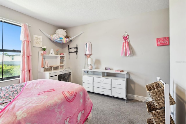 carpeted bedroom featuring a textured ceiling