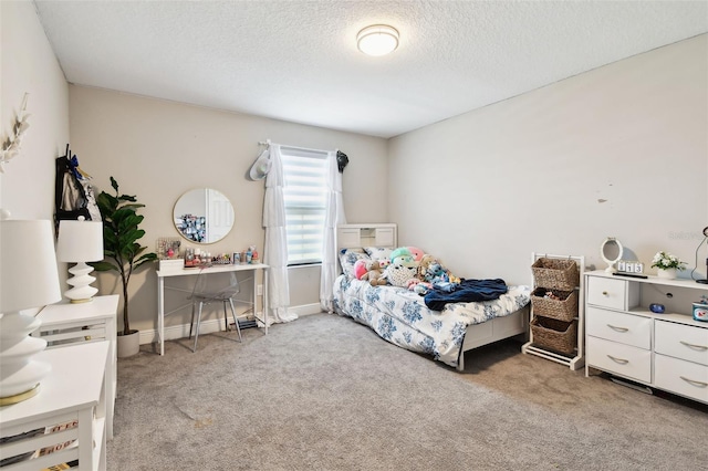 bedroom with light carpet, a textured ceiling, and baseboards