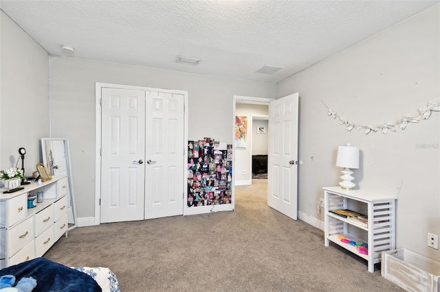 bedroom with light carpet, a closet, and a textured ceiling