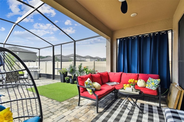 view of patio featuring outdoor lounge area, fence, and a lanai