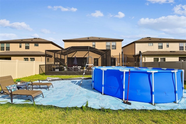 view of pool with a fenced backyard, a patio area, and a lanai