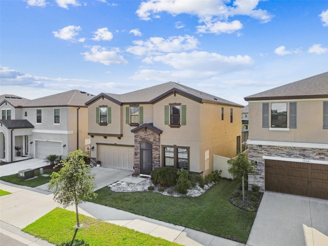 view of property featuring stucco siding, stone siding, driveway, a garage, and a front lawn