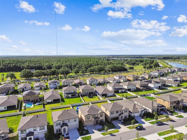 aerial view of residential area featuring a large body of water
