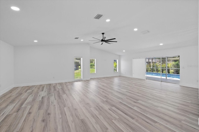 5507 Nimitz Rd, New Port Richey, FL 34652 - unfurnished living room featuring healthy amount of natural light, recessed lighting, vaulted ceiling, light wood-type flooring, and a ceiling fan