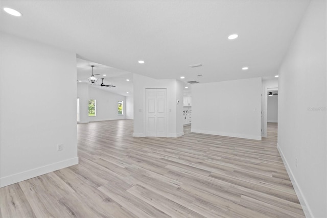 5507 Nimitz Rd, New Port Richey, FL 34652 - unfurnished living room featuring recessed lighting, a ceiling fan, light wood-type flooring, baseboards, and lofted ceiling