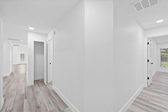5507 Nimitz Rd, New Port Richey, FL 34652 - hallway featuring light wood-style floors, baseboards, and recessed lighting