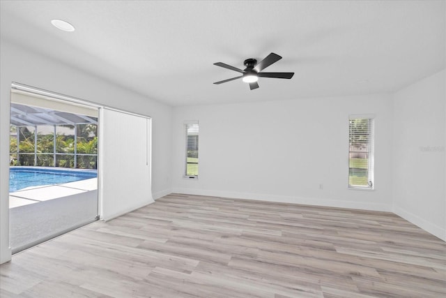 5507 Nimitz Rd, New Port Richey, FL 34652 - unfurnished room with a ceiling fan, plenty of natural light, and light wood-style floors