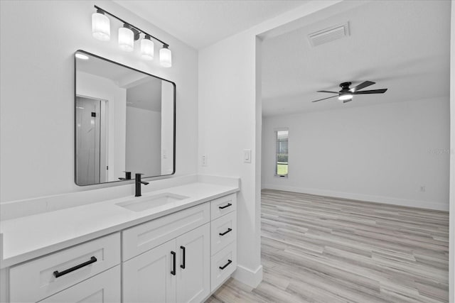 5507 Nimitz Rd, New Port Richey, FL 34652 - bathroom featuring a ceiling fan, wood finished floors, vanity, and baseboards