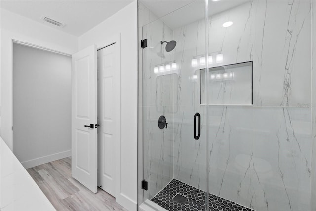 5507 Nimitz Rd, New Port Richey, FL 34652 - full bath with a marble finish shower, wood finished floors, and baseboards