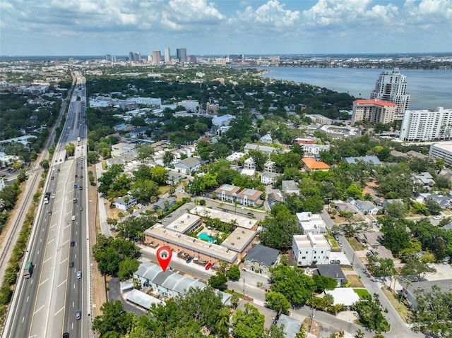view of urban area with a main thoroughfare and a large body of water