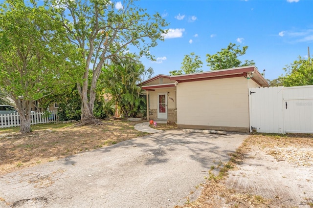 view of front of property featuring fence and a gate