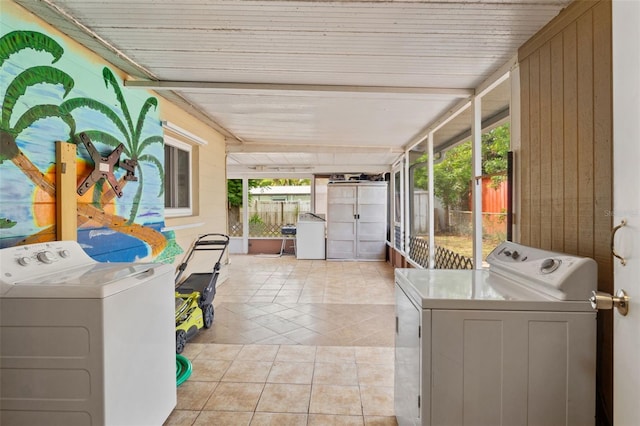 laundry area featuring washer and clothes dryer, light tile patterned floors, and wooden ceiling