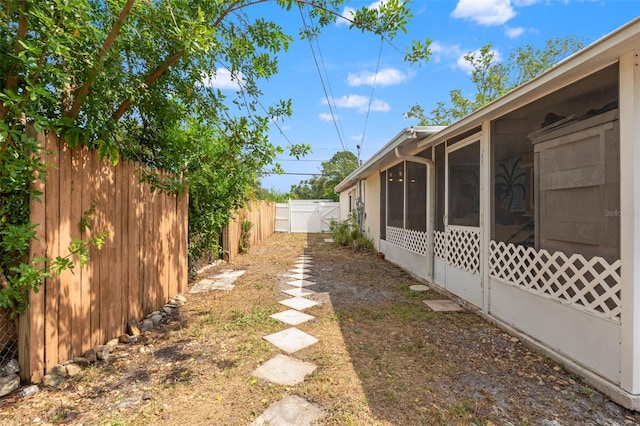 fenced backyard featuring a sunroom