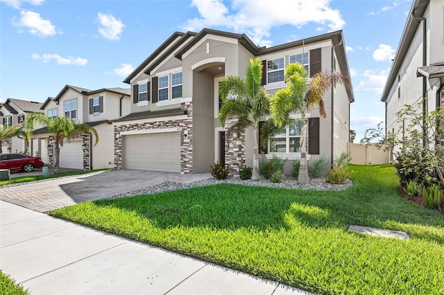 3071 Marine Grass Dr, Wimauma, FL 33598 - multi unit property with stucco siding, a garage, driveway, stone siding, and a residential view
