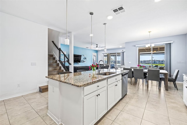3071 Marine Grass Dr, Wimauma, FL 33598 - kitchen featuring a sink, dishwasher, light stone countertops, white cabinets, and light tile patterned flooring