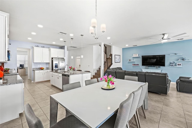 3071 Marine Grass Dr, Wimauma, FL 33598 - dining room featuring stairs, ceiling fan, a chandelier, light tile patterned floors, and recessed lighting