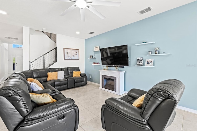 3071 Marine Grass Dr, Wimauma, FL 33598 - living room with stairs, light tile patterned floors, ceiling fan, and baseboards