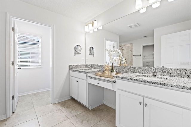 3071 Marine Grass Dr, Wimauma, FL 33598 - full bathroom featuring a stall shower, double vanity, tile patterned flooring, and baseboards