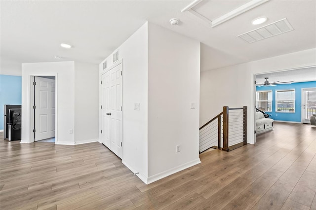 3071 Marine Grass Dr, Wimauma, FL 33598 - hallway with light wood-style flooring, baseboards, attic access, an upstairs landing, and recessed lighting