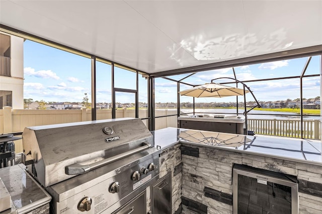 3071 Marine Grass Dr, Wimauma, FL 33598 - sunroom featuring area for grilling, a water view, and beverage cooler